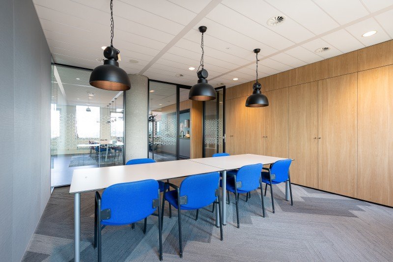 meeting-room-interior-modern-office-with-long-wooden-table-chairs-around-it (1)
